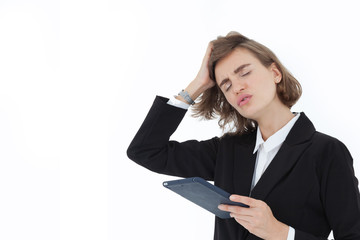 A beautiful business woman in a suit is stressed and annoyed, and holding a tablet in the other hand, on a white background in the concept of business success and inciting unity. 