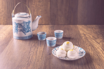 Chinese pastry or moon cake with Chinese dragon pattern teapots and teacups,Homemade and asian dessert concept.