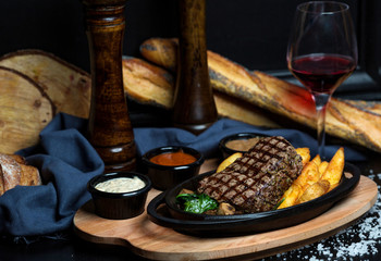 beef steak with fried potatoes, mayonnaise, mustard and ketchup