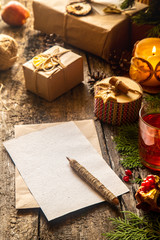 Zero west and eco friendly christmas concept flat lay with gift, branches and candle on rustic wooden background. making handmade eco friendly Christmas decor.