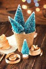 Artificial little Christmas treees in biodegradable peat moss and wooden shavings. Eco-friendly New Year and Christmas