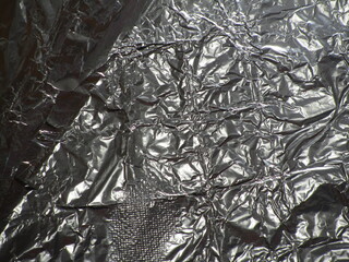 Abstract silver background. Crumpled aluminum foil texture.