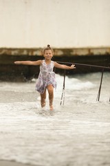 Happy girl is running on the sea shore. Summer holidays. 