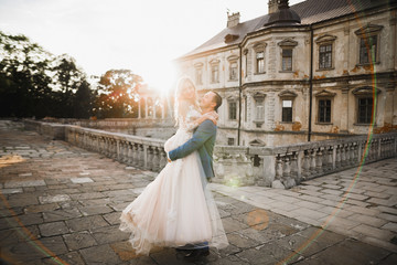 Obraz premium Wedding couple on the nature is hugging each other. Beautiful model girl in white dress. Man in suit