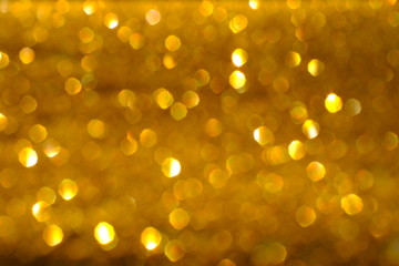 Blurry abstract golden background with bokeh lights