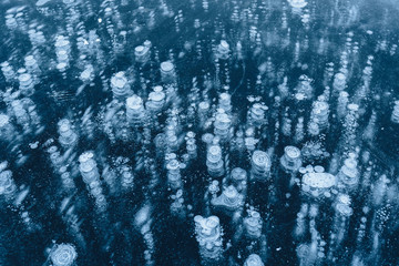  ice texture with frozen air bubbles. winter dark background