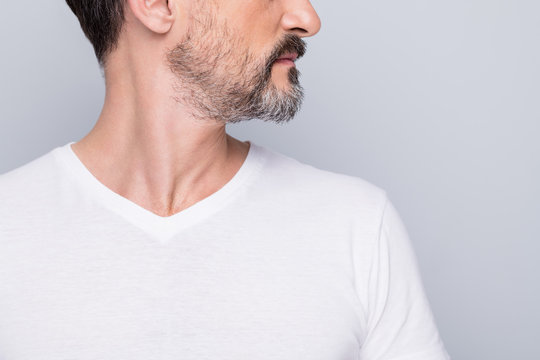 Closeup cropped photo of attractive aged man seriously looking side empty space mature wrinkles appearance showing nice beard wear white t-shirt isolated grey color background