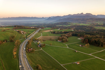 Top down aerial view of freeway interstate road with moving traffic cars in rural area.