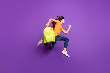 Full length body size view of her she nice attractive lovely purposeful cheerful cheery wavy-haired girl jumping carrying bag running first lesson isolated on lilac purple violet pastel color