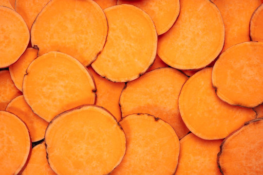 Agricultural Sweet Potato Vegetable Cut Slices. Heap of Dietary Natural Product Orange Batata. Ready Ingredient for Bake, Fry or Boil Staple Meal. Farmland Grocery Nutrition Top View Photo