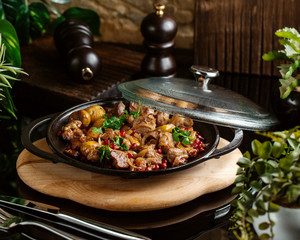 azerbaijani traditional dish ash-gara roasted meat with dried fruits topped with herbs