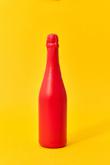 Red painted spray mockup bottle on an yellow background.