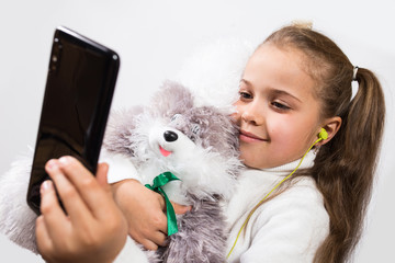 Girl with phone and plush toy