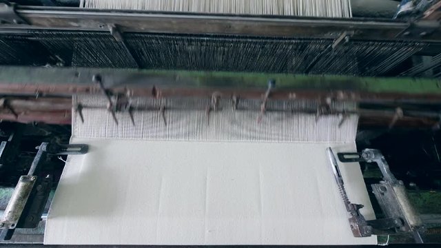 Process of fabric weaving at a modern textile factory.