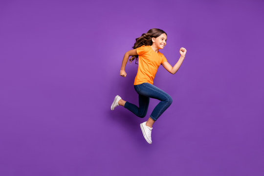 Full length body size profile side view of her she nice attractive glad cheerful cheery wavy-haired girl jumping running hobby free time isolated over lilac purple violet pastel color background