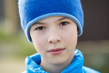 Close up portrait of cute child boy in a cap.
