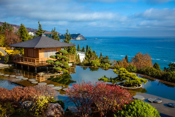 Japanese garden with tea house overlooking the sea.