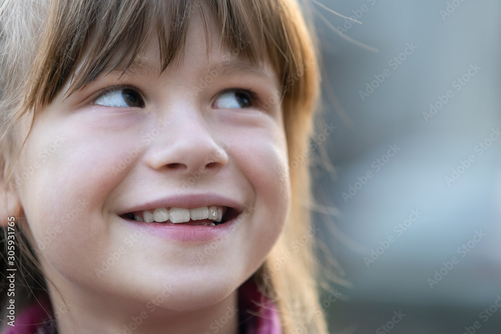 Wall mural portrait of happy child girl in warm clothes in autumn outdoors.