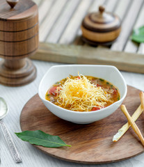 vegetable soup topped with potato shoestrings served with bread sticks