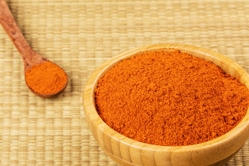 Bowl full of Chili Powder on a bamboo background