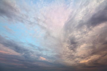 Sunset sky covered with orange puffy clouds in the evening.
