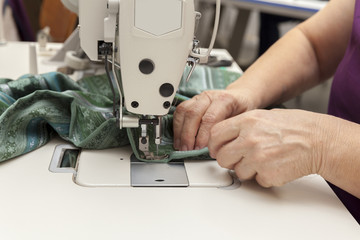 seamstress works on the sewing machine