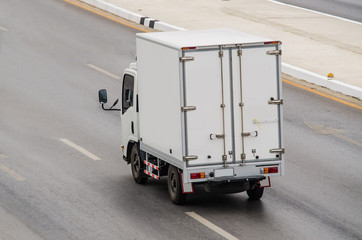 Samut Sakhon, Thailand - May 2019: Small white truck running on Rama II Road on May 26, 2019 in Samut Sakhon, Thailand.