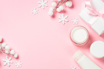 Obraz na płótnie Canvas Winter cream for skin on pink top view.