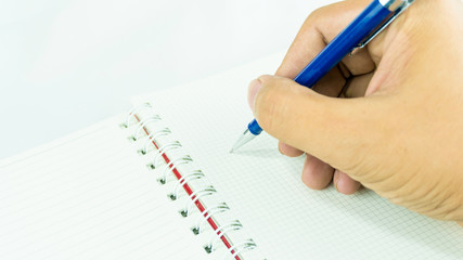 Hand hold pencil for writing and sign on the notebook
