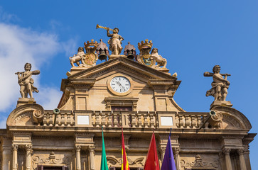 Fototapeta na wymiar Pamplona, Spain. The pediment of the facade of City Hall with a clock and statues, XVIII century.