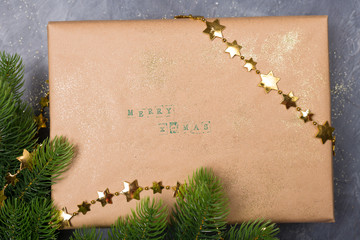 Christmas gift boxes decorated with craft paper, branch on dark background . Merry greeting card. Winter holiday theme.  © Anna Niki
