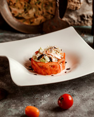 portioned vegetable salad surrounded with tomato slices