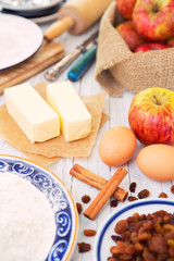 Ingredients for an apple pie on a rustic table