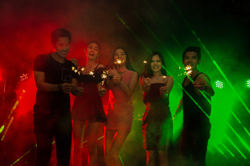 Fototapeta premium Holiday celebrations concept, Traveller people dancing together with enjoying at colourful night party club.