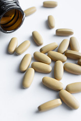 Scatterded yellow pills on white background 