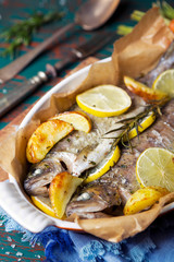 Oven roasted trout in a casserole on a rustic table