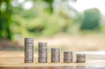 Pile coin with green light background, save growing money concept