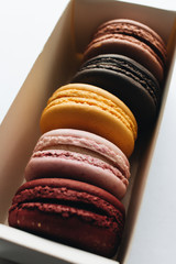 Box with delicious bright macaroons, sweet dessert 