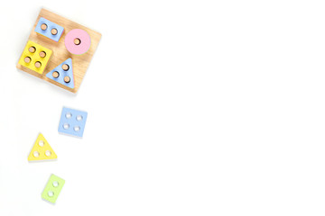 Wooden pastel color geometry educational toy for children on white background. Educational shape color recognition puzzle stacker. Early childhood development puzzle toys