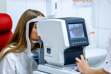 patient in ophthalmology clinic during the study of computer vision defects. Ophthalmologist....