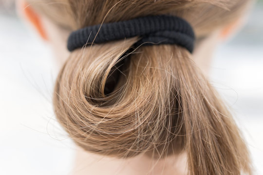 Close Up Of Blonde Fair Casual Hair Bun In Pony Tail, Macro