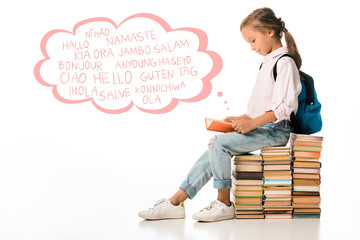 cheerful schoolkid sitting on books and reading near greeting letters on white © LIGHTFIELD STUDIOS