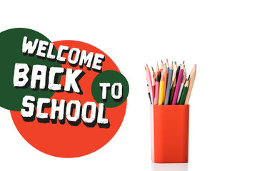 pen holder with multicolored pencils near welcome back to school letters on white