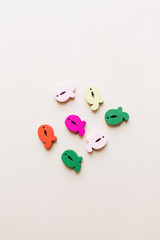 Colorful small scattered wooden Q letters 