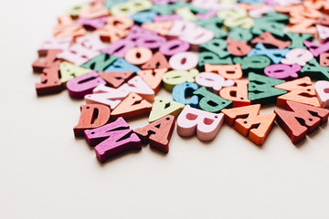 Colorful small scattered wooden letters