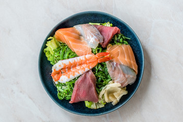 Sashimi Salad with Wakame, Seaweed, Salmon, Sea Bass, Shrimp, Kani, Mackerel Fish, Tuna served with Chopsticks.