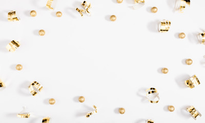 Christmas holiday composition. Golden decorations on white background. Christmas, New Year, winter concept. Flat lay, top view, copy space
