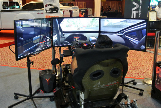 KUALA LUMPUR, MALAYSIA -APRIL 8, 2017: Simulation Of Race Car Video Player Game With Big Screen Monitors And Cockpit Controls Like A Racing Car.