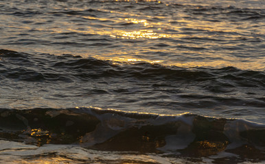Black and gold waves of Black Sea at dawn. Natural background for any design.