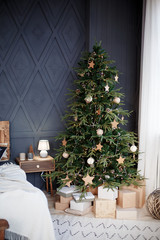 Christmas decorations. Cozy interior in pastel shades. Christmas tree with decorations and gifts